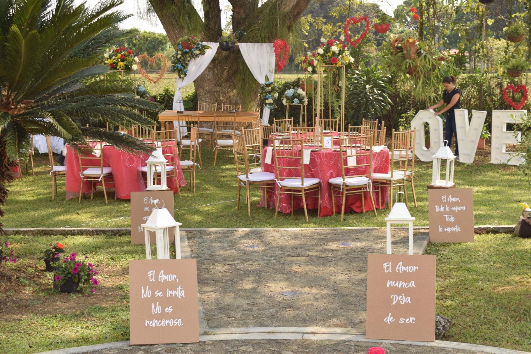 Entrada decorada con letreros de amor para boda en jardín
